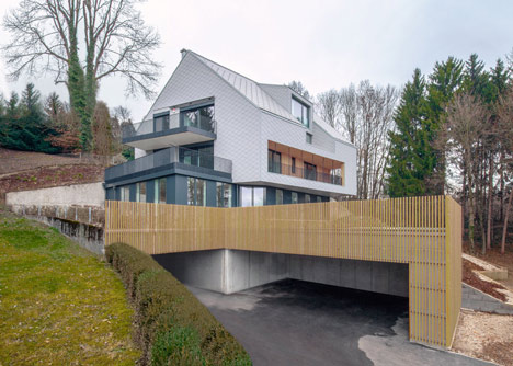 House B.A.B.E. by Destilat features windows dotted across shingle-clad facade