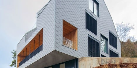 House B.A.B.E. by Destilat features windows dotted across shingle-clad facade