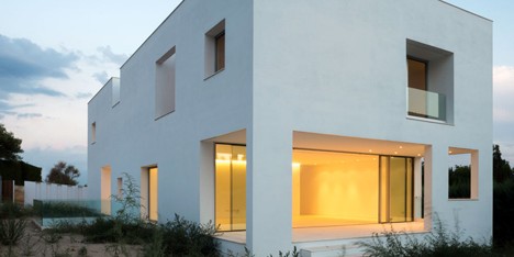 House H by Bojaus Arquitectura features a facade covered in holes