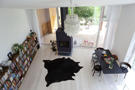 Timber-clad House M-M by Tuomas Siitonen wraps around a sheltered garden