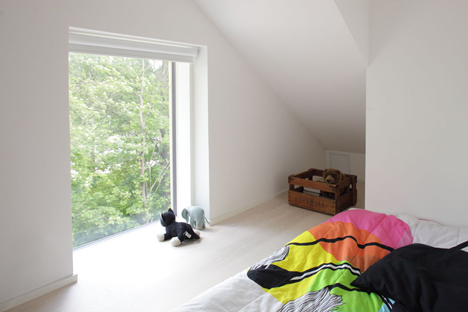 Timber-clad House M-M by Tuomas Siitonen wraps around a sheltered garden