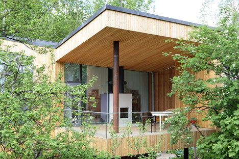 Timber-clad House M-M by Tuomas Siitonen wraps around a sheltered garden