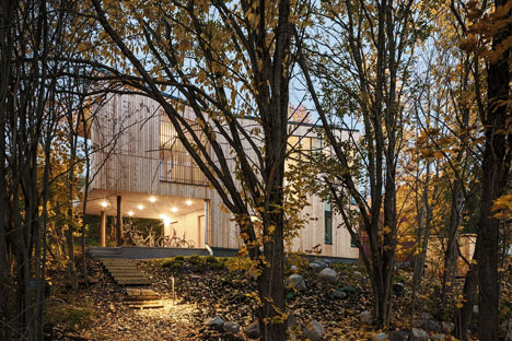 Timber-clad House M-M by Tuomas Siitonen wraps around a sheltered garden