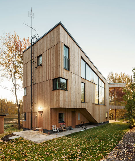 Timber-clad House M-M by Tuomas Siitonen wraps around a sheltered garden