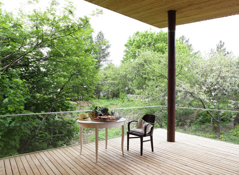 Timber-clad House M-M by Tuomas Siitonen wraps around a sheltered garden
