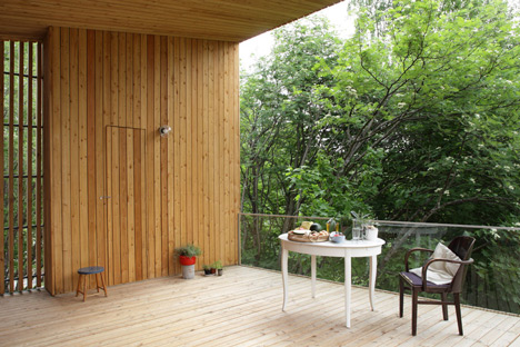 Timber-clad House M-M by Tuomas Siitonen wraps around a sheltered garden