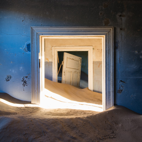 Ghost town engulfed by mounds of sand in photography by Romain Veillon