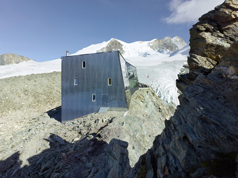 Steel-clad mountain hut by Savioz Fabrizzi Architectes wraps over an Alpine ridge
