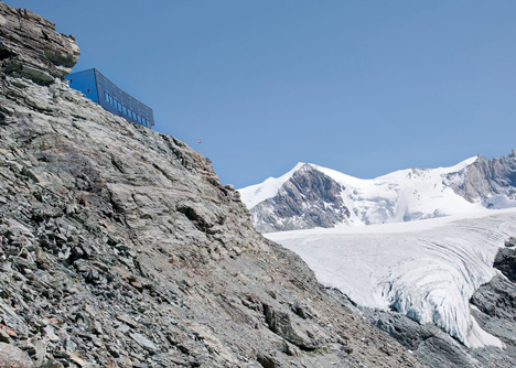 Steel-clad mountain hut by Savioz Fabrizzi Architectes wraps over an Alpine ridge