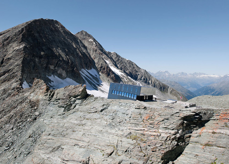 Steel-clad mountain hut by Savioz Fabrizzi Architectes wraps over an Alpine ridge
