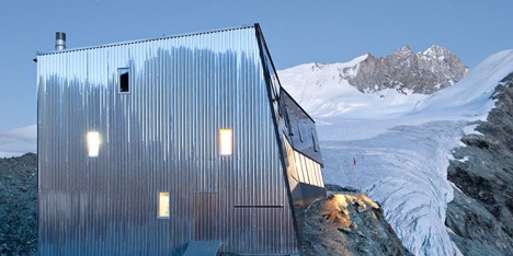 Steel-clad mountain hut by Savioz Fabrizzi Architectes wraps over an Alpine ridge
