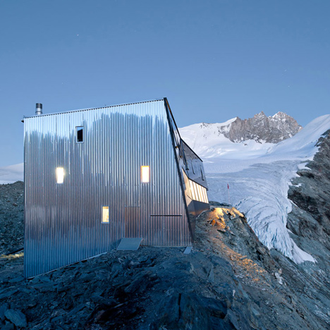 Steel-clad mountain hut by Savioz Fabrizzi Architectes wraps over an Alpine ridge