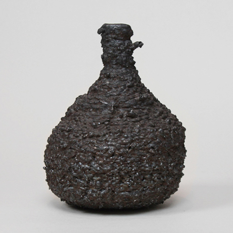 Josh Bitelli uses welding equipment to make containers from coils of molten steel