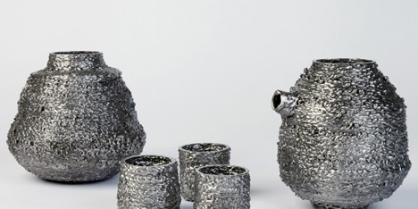Josh Bitelli uses welding equipment to make containers from coils of molten steel