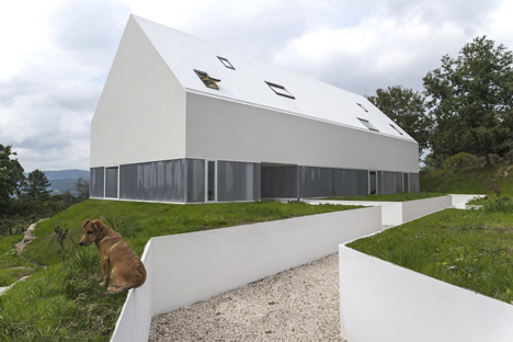 White buildings sink into the landscape at the White Wolf Hotel by AND-RÉ