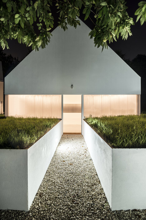 White buildings sink into the landscape at the White Wolf Hotel by AND-RÉ