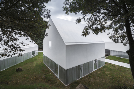 White buildings sink into the landscape at the White Wolf Hotel by AND-RÉ