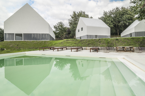 White buildings sink into the landscape at the White Wolf Hotel by AND-RÉ