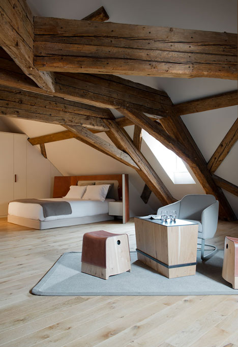Wooden strips coil around staircase at Strasbourg hotel by Jouin Manku
