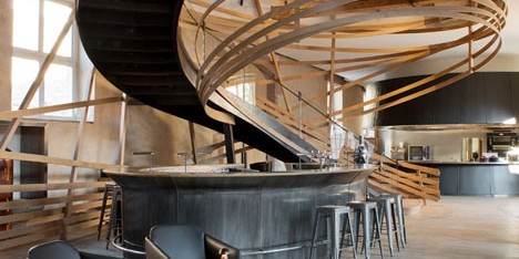 Wooden strips coil around staircase at Strasbourg hotel by Jouin Manku