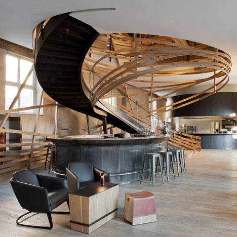 Wooden strips coil around staircase at Strasbourg hotel by Jouin Manku