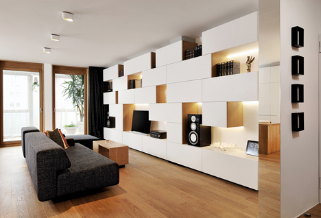 Studio 360 adds walls of modular shelving and storage to Slovenian apartment