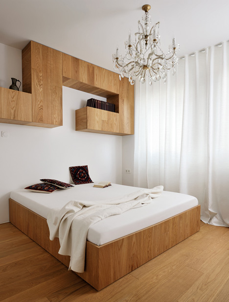 Studio 360 adds walls of modular shelving and storage to Slovenian apartment