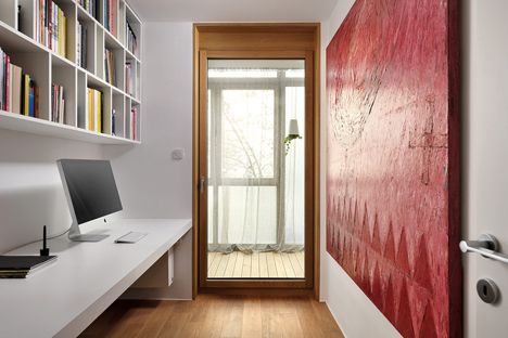 Studio 360 adds walls of modular shelving and storage to Slovenian apartment