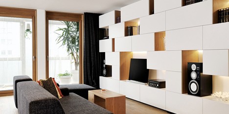 Studio 360 adds walls of modular shelving and storage to Slovenian apartment
