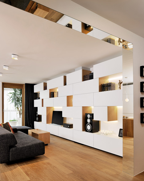 Studio 360 adds walls of modular shelving and storage to Slovenian apartment