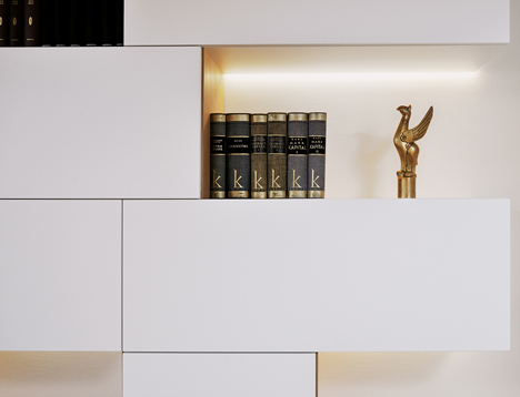 Studio 360 adds walls of modular shelving and storage to Slovenian apartment