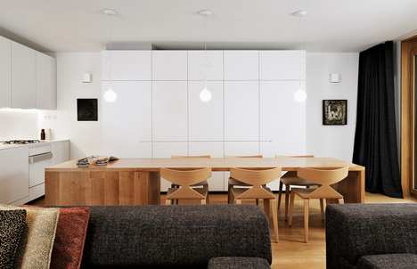 Studio 360 adds walls of modular shelving and storage to Slovenian apartment