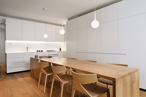Studio 360 adds walls of modular shelving and storage to Slovenian apartment