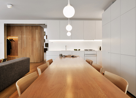 Studio 360 adds walls of modular shelving and storage to Slovenian apartment