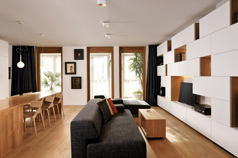 Studio 360 adds walls of modular shelving and storage to Slovenian apartment