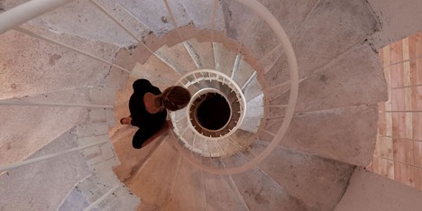 Concrete staircase spirals up through Pezo von Ellrichshausens Casa Gago