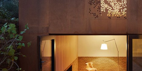 Weathered steel sits alongside ageing brickwork at Kew House by Piercy & Company