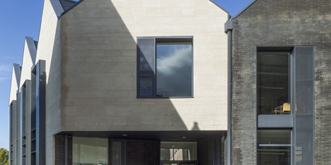 School building by Mitchell Taylor Workshop contrasts pale stone with grey brick