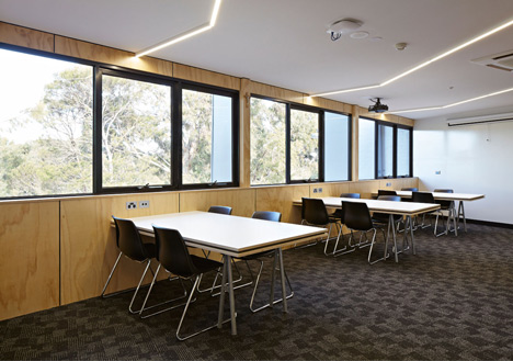 Timber-clad school library extended into the tree tops by Branch Studio Architects