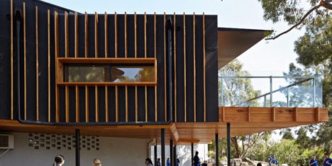 Timber-clad school library extended into the tree tops by Branch Studio Architects