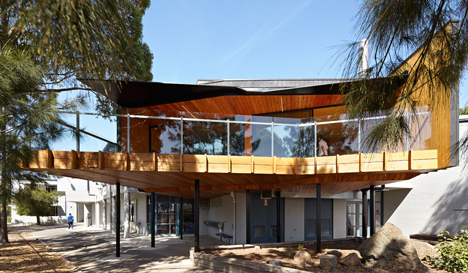 Timber-clad school library extended into the tree tops by Branch Studio Architects