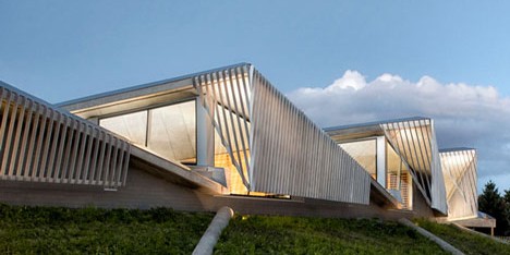 Water treatment facility by Skylab Architecture features a roof of grass-covered fins