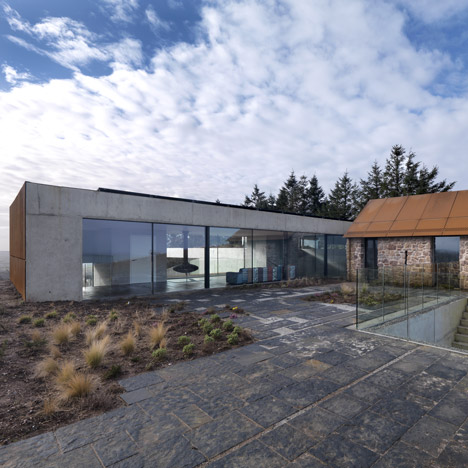 Loyn & Co’s Stormy Castle house pairs concrete and glass with traditional stone