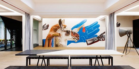 Simon Bush-King adds chipboard furniture and wall art to Superheroes’ office