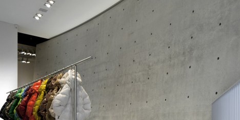 Tadao Ando divides Duvetica store with curved concrete wall