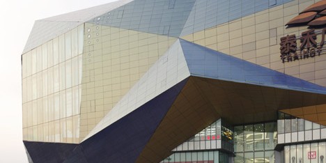 Spark incorporates giant screens into faceted shopping centre facade