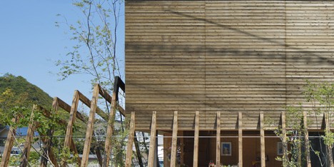 Wooden ribs frame entrance to timber-clad gallery by UID Architects
