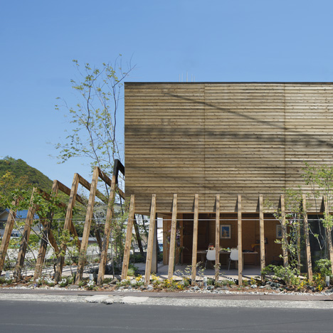 Wooden ribs frame entrance to timber-clad gallery by UID Architects