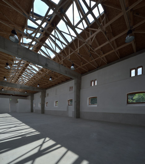 3+1 Architekti converts a stone barn into a woodwork facility with a serrated timber extension