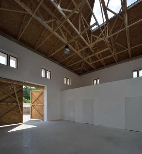 3+1 Architekti converts a stone barn into a woodwork facility with a serrated timber extension